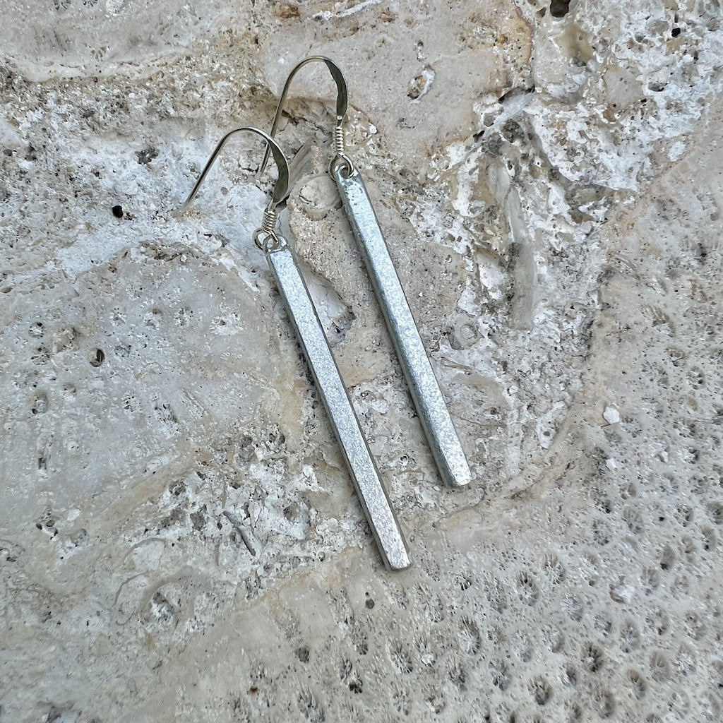 recycled bomb earrings bar
