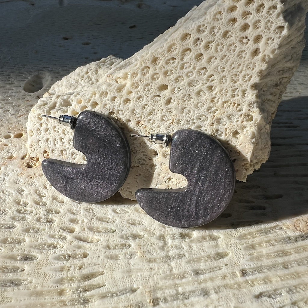 Pair of dark gray half-circle earrings on a white background