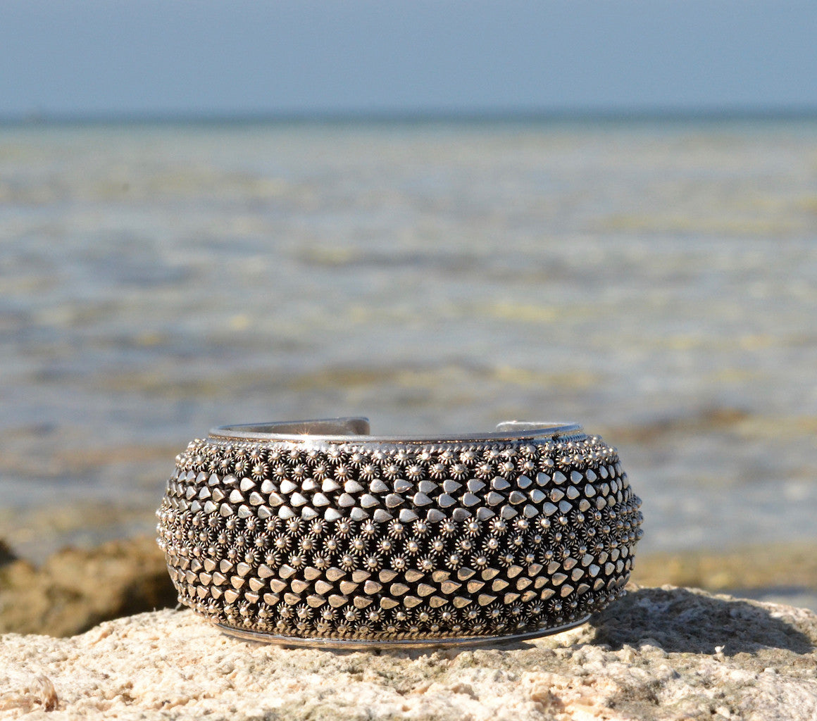 Silver snake cuff bracelet on beach